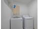 A clean laundry room with new front loading washer and dryer and window at 8404 Shore Breeze Dr, Las Vegas, NV 89128