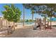 Community playground area with sand and shade near the water, providing recreation for residents at 8404 Shore Breeze Dr, Las Vegas, NV 89128