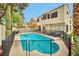 Backyard pool with a safety fence, adjacent seating area for entertaining, and privacy from neighboring homes at 8404 Shore Breeze Dr, Las Vegas, NV 89128