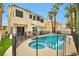 Backyard pool and spa area, surrounded by a -proof safety fence and lush desert landscaping, perfect for relaxation at 8404 Shore Breeze Dr, Las Vegas, NV 89128