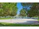 Community volleyball court with lush greenery surrounding a tranquil lake at 8404 Shore Breeze Dr, Las Vegas, NV 89128