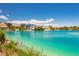 Stunning lake view showcasing luxurious waterfront homes with lush landscaping and clear blue waters at 8404 Shore Breeze Dr, Las Vegas, NV 89128