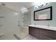 Bright bathroom featuring a glass enclosed shower and a double sink vanity with modern fixtures at 8705 Orvieto Dr, Las Vegas, NV 89117