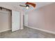 Bedroom features a closet with shelving, ceiling fan, and access to another room at 8705 Orvieto Dr, Las Vegas, NV 89117
