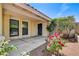 Home entryway with desert landscaping, mature trees, and a covered porch at 8705 Orvieto Dr, Las Vegas, NV 89117
