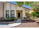 Covered front porch featuring a brick border and desert landscaping at 8705 Orvieto Dr, Las Vegas, NV 89117
