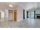 Front entryway with wood door, light fixture and coat closet at 8705 Orvieto Dr, Las Vegas, NV 89117