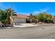 Well-maintained single-story home with a lush landscaped yard and mature trees at 8705 Orvieto Dr, Las Vegas, NV 89117