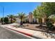 Charming single-story home with a tile roof, landscaped front yard, and mature trees at 8705 Orvieto Dr, Las Vegas, NV 89117