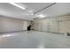 This is a spacious two-car garage with ample storage, updated lighting, and epoxy flooring providing functionality at 8705 Orvieto Dr, Las Vegas, NV 89117