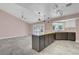 Open kitchen with butcher block island, stainless fridge, and modern lighting at 8705 Orvieto Dr, Las Vegas, NV 89117