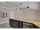 Kitchen island with gray cabinets and butcher block countertop provides ample prep space at 8705 Orvieto Dr, Las Vegas, NV 89117