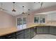 Kitchen with butcher block countertops and gray cabinets overlooks backyard at 8705 Orvieto Dr, Las Vegas, NV 89117
