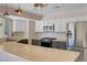 Kitchen with stainless refrigerator, butcher block countertops, and gas cooktop range at 8705 Orvieto Dr, Las Vegas, NV 89117