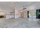 Open living room with washer and dryer, stone-look tile flooring and fireplace at 8705 Orvieto Dr, Las Vegas, NV 89117