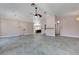 Open floor plan features stone-look tile flooring and vaulted ceiling with ceiling fan at 8705 Orvieto Dr, Las Vegas, NV 89117