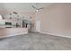 Open living room area flows into a spacious kitchen with stone-look tile floors at 8705 Orvieto Dr, Las Vegas, NV 89117