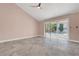 Open living room with sliding door to yard, tile floors and vaulted ceilings at 8705 Orvieto Dr, Las Vegas, NV 89117