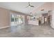 Living room flows into the kitchen area with tile flooring and modern appliances at 8705 Orvieto Dr, Las Vegas, NV 89117