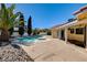 A sparkling pool features a spa and lush landscaping creating a private oasis in the backyard at 8705 Orvieto Dr, Las Vegas, NV 89117