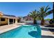 This backyard features an in-ground pool, lush landscaping and is fully fenced for privacy at 8705 Orvieto Dr, Las Vegas, NV 89117