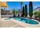 Enjoy this in-ground pool and spa combination amidst tropical landscaping and a privacy fence at 8705 Orvieto Dr, Las Vegas, NV 89117