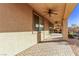 Covered back patio with brick flooring and manicured landscaping at 8797 Pinley Spring St, Las Vegas, NV 89113