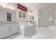Primary bathroom with marble floors, walk-in shower, soaking tub, and dual vanities at 8797 Pinley Spring St, Las Vegas, NV 89113