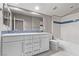 Modern bathroom featuring double sinks, a large mirror, and a shower/tub combo at 8797 Pinley Spring St, Las Vegas, NV 89113
