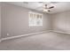 Neutral bedroom featuring carpet flooring, a ceiling fan, a large window, and light gray walls at 8797 Pinley Spring St, Las Vegas, NV 89113
