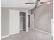 Cozy bedroom featuring a ceiling fan, closet with sliding doors and a doorway leading to the next room at 8797 Pinley Spring St, Las Vegas, NV 89113