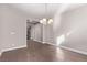 Dining room featuring hardwood floors, gray walls, white trim, and a modern chandelier at 8797 Pinley Spring St, Las Vegas, NV 89113