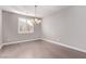 Dining room features a modern chandelier, plantation shutters and hardwood floors at 8797 Pinley Spring St, Las Vegas, NV 89113