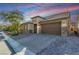 Beautiful single-story home with a stone accent, wide driveway, and manicured landscaping at 8797 Pinley Spring St, Las Vegas, NV 89113