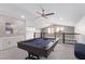 Spacious game room featuring a stylish pool table, ceiling fan, and wet bar for entertainment at 8797 Pinley Spring St, Las Vegas, NV 89113