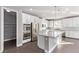 Modern kitchen with white cabinets, large island, and stainless steel appliances at 8797 Pinley Spring St, Las Vegas, NV 89113