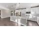 Stylish kitchen boasts a large island, stainless steel appliances, and white cabinets at 8797 Pinley Spring St, Las Vegas, NV 89113