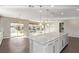 Open concept kitchen showcasing a large island, stainless steel appliances, and backyard access at 8797 Pinley Spring St, Las Vegas, NV 89113