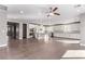 Spacious kitchen and living area featuring white cabinets, stainless steel appliances, and hardwood floors at 8797 Pinley Spring St, Las Vegas, NV 89113