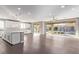 Expansive living area featuring hardwood floors and large windows with a view of the backyard at 8797 Pinley Spring St, Las Vegas, NV 89113