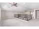 Large carpeted loft space featuring a ceiling fan and access to a walk-in closet at 8797 Pinley Spring St, Las Vegas, NV 89113