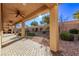 Covered patio features brick pavers, ceiling fans, and access to landscaped backyard at 8797 Pinley Spring St, Las Vegas, NV 89113