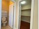 Powder room featuring a toilet, storage cabinet, and an open view into the closet at 9138 Hermosa Valley St, Las Vegas, NV 89178