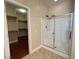 Bathroom with a glass-enclosed shower and a view into the spacious walk-in closet at 9138 Hermosa Valley St, Las Vegas, NV 89178