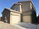 Beige two-story home featuring a two-car garage and low maintenance landscaping at 9138 Hermosa Valley St, Las Vegas, NV 89178