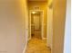 Hallway with tan walls, tiled flooring, and white doors leading to various rooms at 9138 Hermosa Valley St, Las Vegas, NV 89178