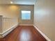 Bright hallway featuring hardwood floors, natural light from a window, and neutral-toned walls at 9138 Hermosa Valley St, Las Vegas, NV 89178