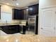 A bright kitchen featuring stainless steel appliances, modern fixtures, and granite countertops at 9138 Hermosa Valley St, Las Vegas, NV 89178