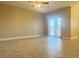Large living room with neutral tones, sliding glass doors and tile flooring at 9138 Hermosa Valley St, Las Vegas, NV 89178