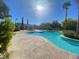 Community pool with palm trees, lounge seating and a well kept pool house at 9138 Hermosa Valley St, Las Vegas, NV 89178